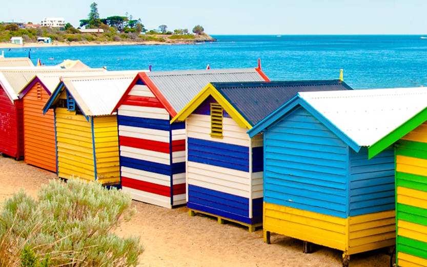 Brighton Bathing Boxes along the sandy beach with ocean view in Melbourne, Australia.