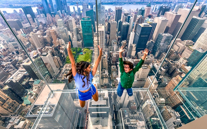 Visitors enjoying the glass observation deck at SUMMIT One Vanderbilt, New York City.