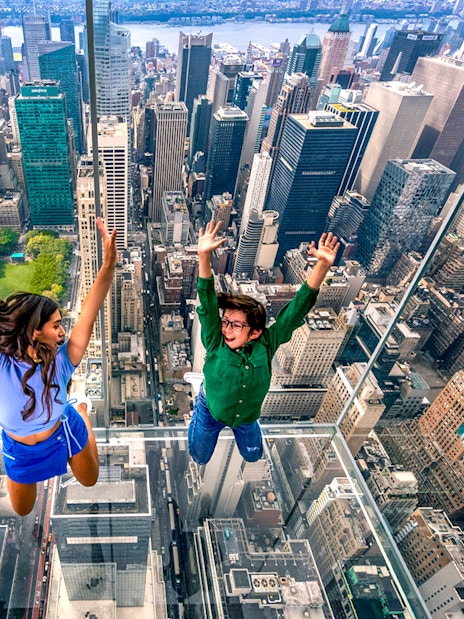 Visitors enjoying the glass observation deck at SUMMIT One Vanderbilt, New York City.