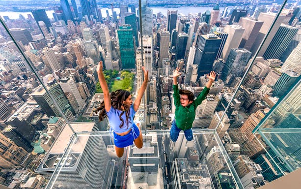 Visitors enjoying the glass observation deck at SUMMIT One Vanderbilt, New York City.