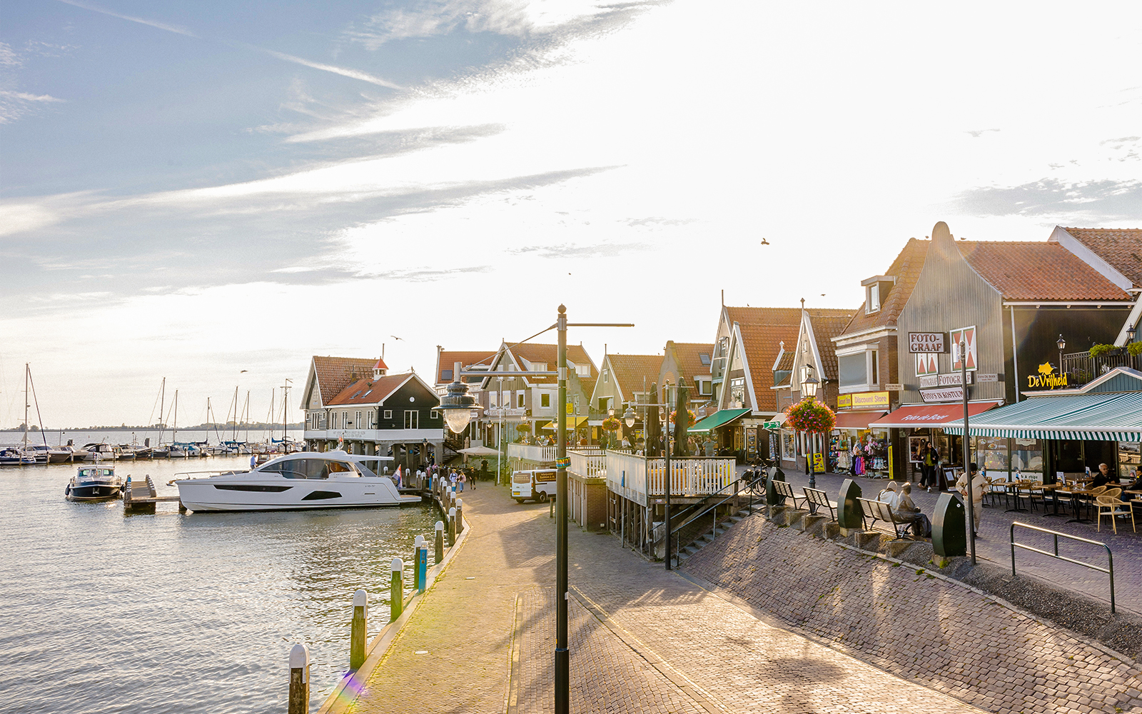 Volendam waterfront with boats docked and traditional Dutch houses.
