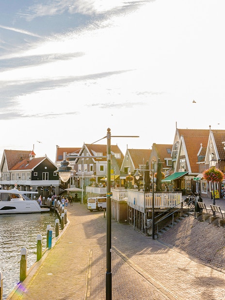 Volendam waterfront with boats docked and traditional Dutch houses.
