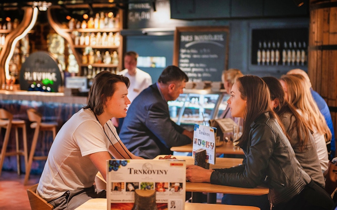 Visitors enjoying a tasting at the Slivovitz Museum bar.