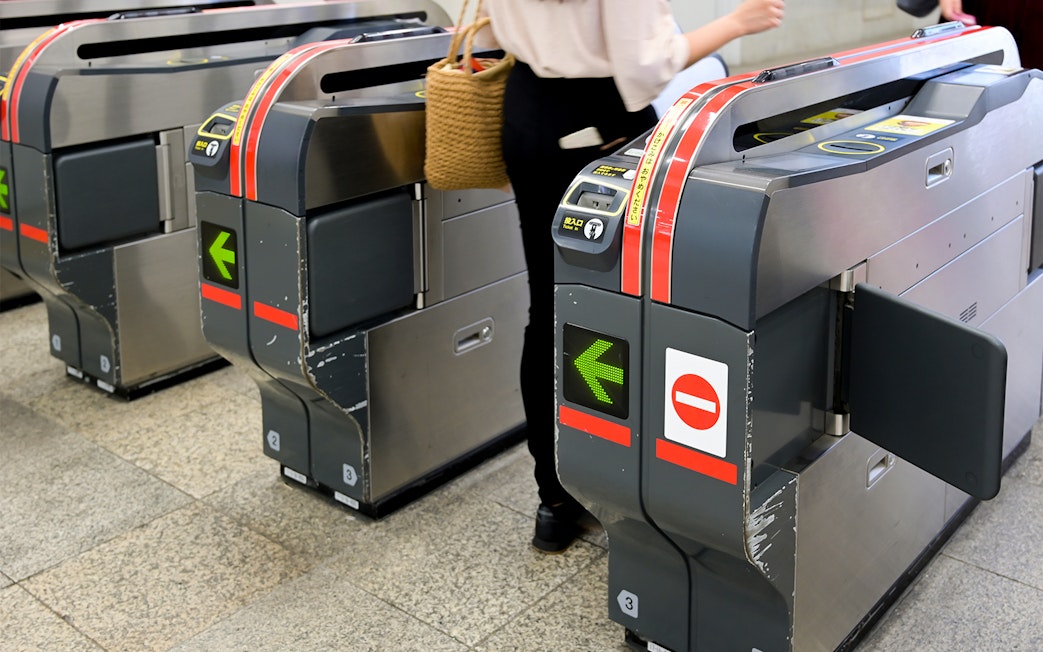 Tokyo subway turnstiles with a person entering using a 24-hour ticket.