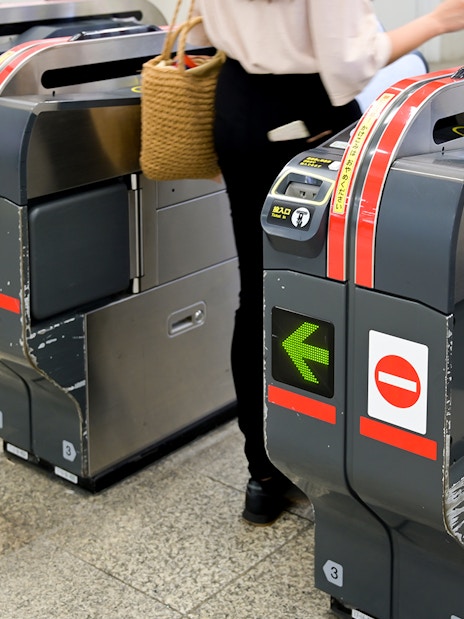 Tokyo subway turnstiles with a person entering using a 24-hour ticket.