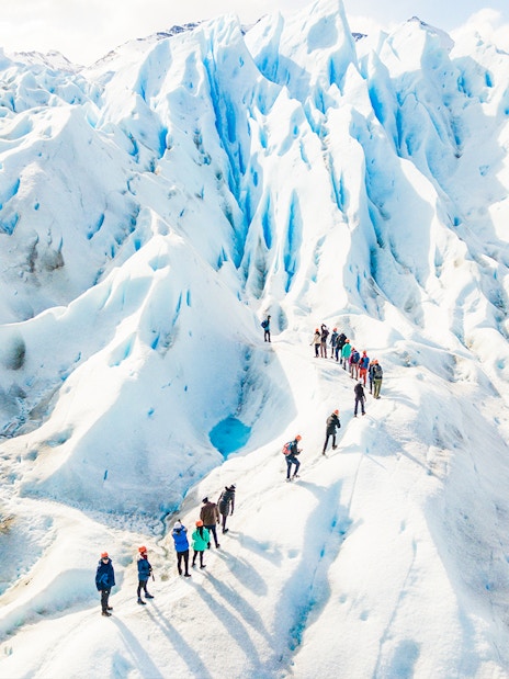 Tourists with guide hiking on Perito Moreno Glacier, Argentina.