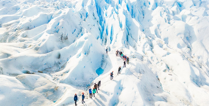Tourists with guide hiking on Perito Moreno Glacier, Argentina.