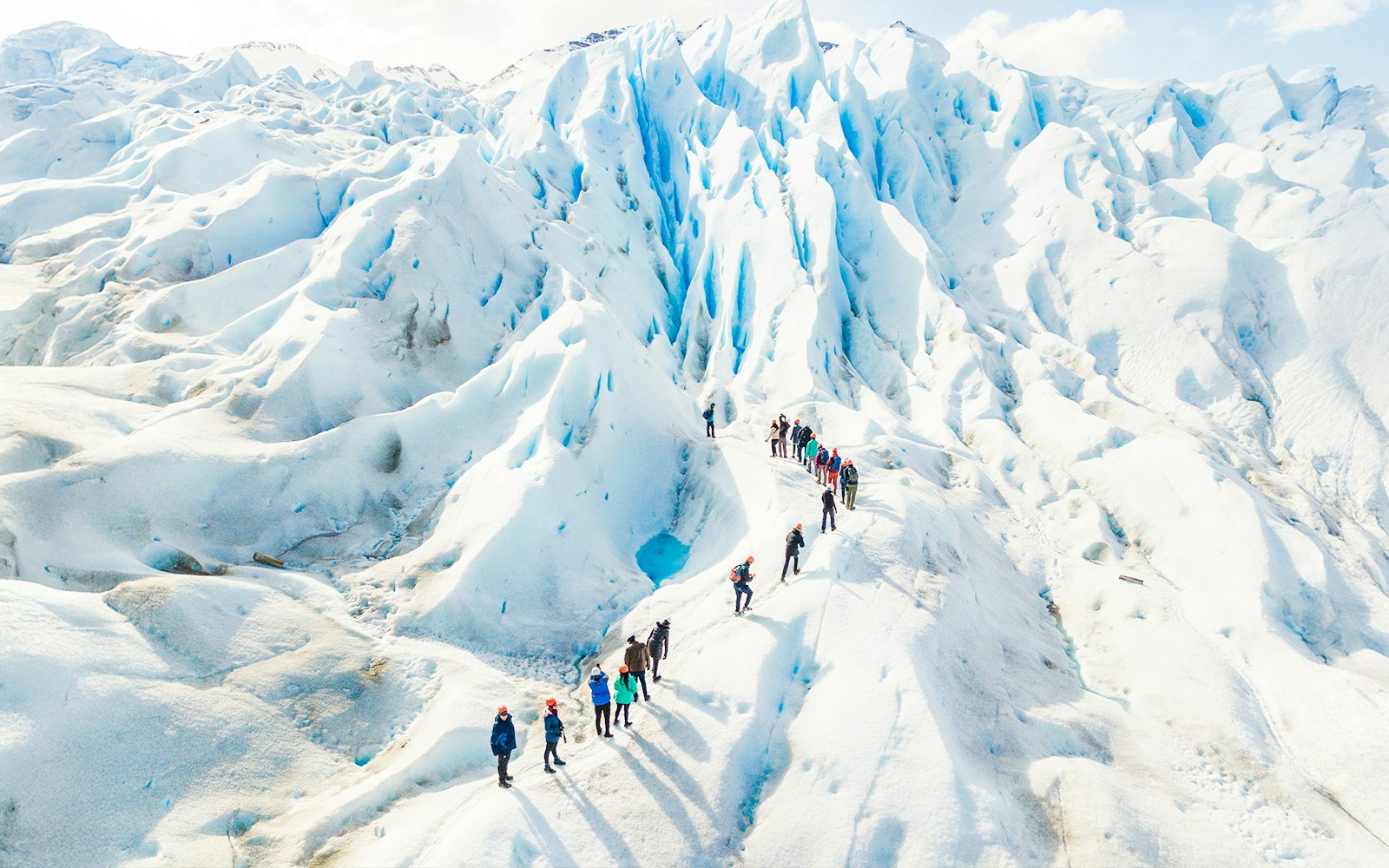Tourists with guide hiking on Perito Moreno Glacier, Argentina.