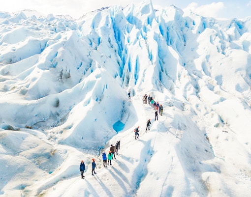 Tourists with guide hiking on Perito Moreno Glacier, Argentina.
