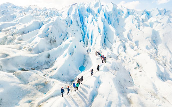 Tourists with guide hiking on Perito Moreno Glacier, Argentina.