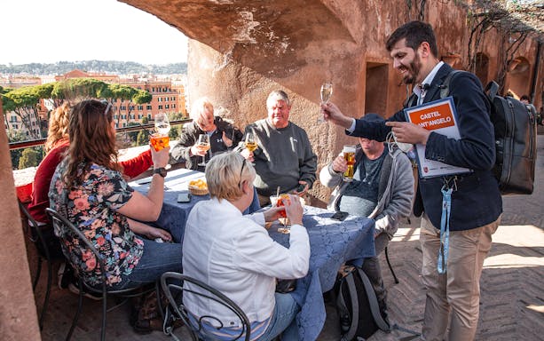 Tour group enjoying drinks on Castel Sant’Angelo terrace in Rome.