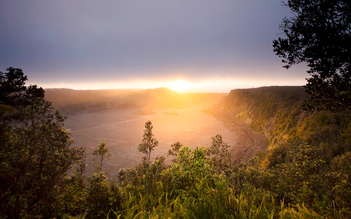 Sunrise over a volcanic crater in Hawaii, part of the Volcano, Chocolate & Waterfall Adventure.