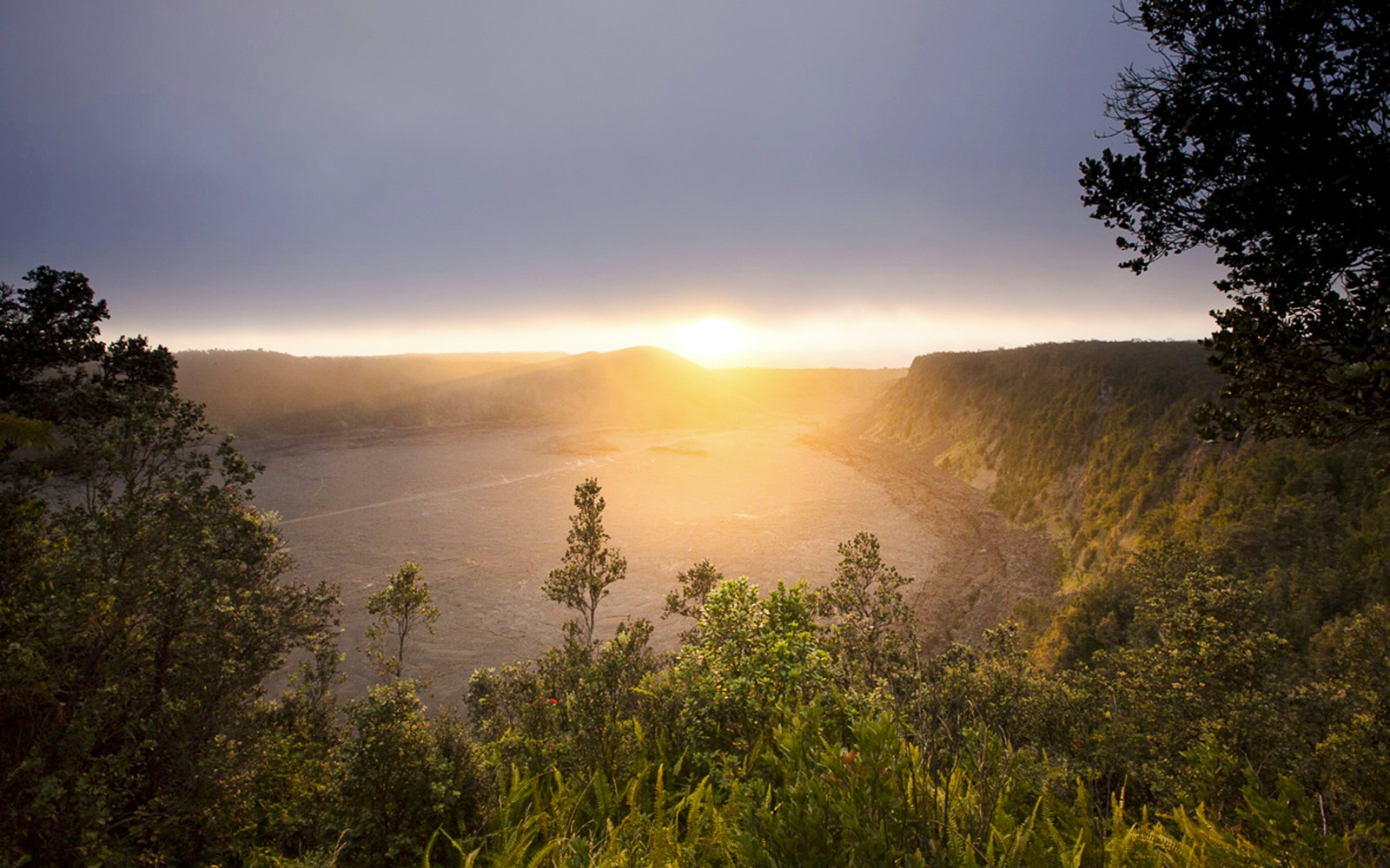 Sunrise over a volcanic crater in Hawaii, part of the Volcano, Chocolate & Waterfall Adventure.