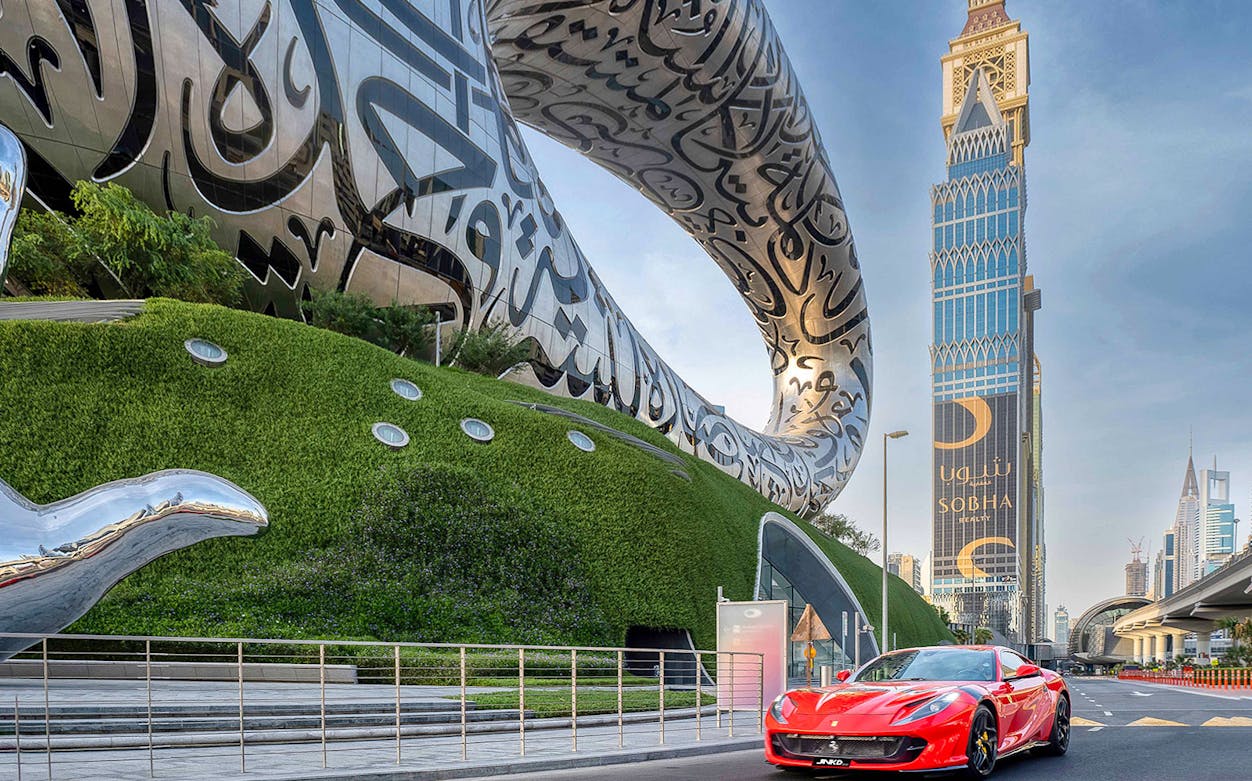 Ferrari 812 Superfast parked in front of Dubai's Museum of the Future.