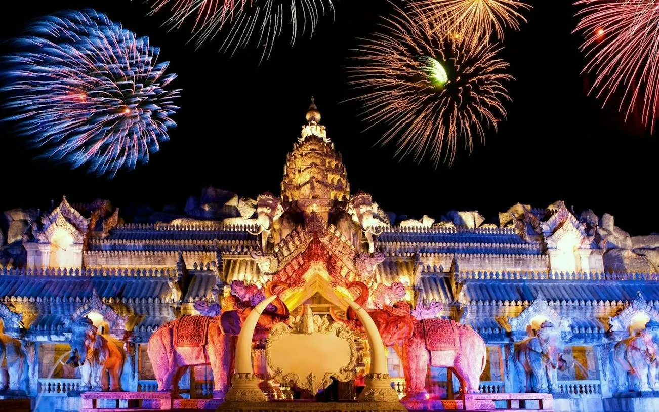 Phuket FantaSea Show with fireworks over ornate Thai architecture.