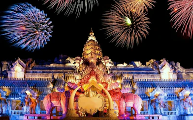 Phuket FantaSea Show with fireworks over ornate Thai architecture.