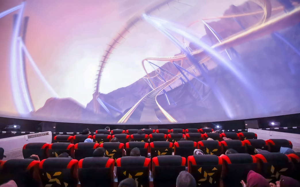 Visitors watching a roller coaster simulation at SkyDome, Langkawi.