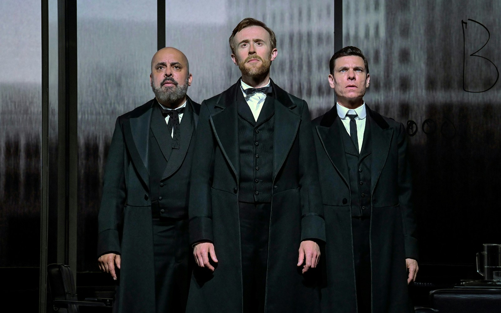 Three actors in period costumes performing in "The Lehman Trilogy" play.