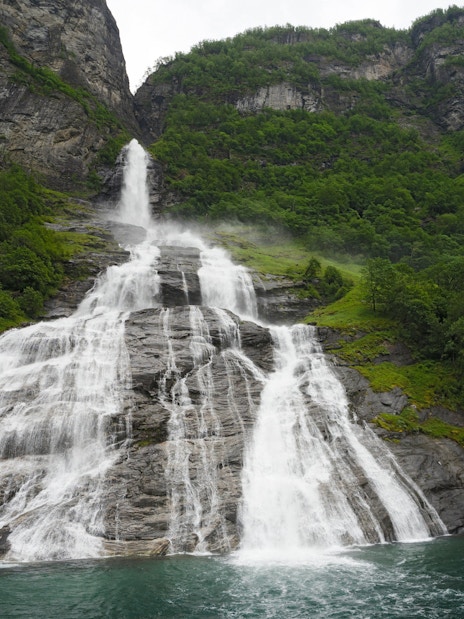 Bridal Veil Waterfall cascading down rocky cliffs in Geiranger, Norway.