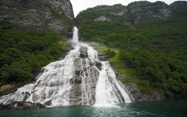 Bridal Veil Waterfall cascading down rocky cliffs in Geiranger, Norway.