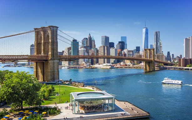 Brooklyn Bridge spanning East River with New York City skyline in the background.