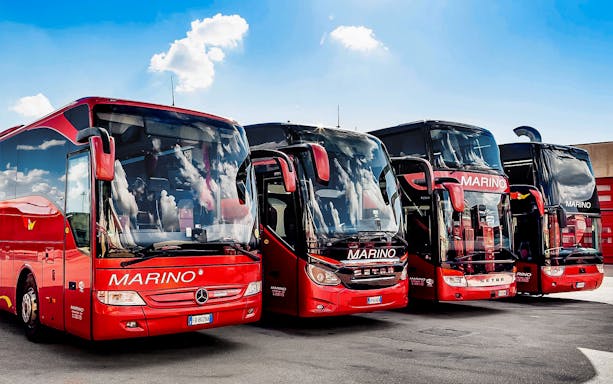 Marino buses parked for round-trip tickets between Matera and Naples Metropark.