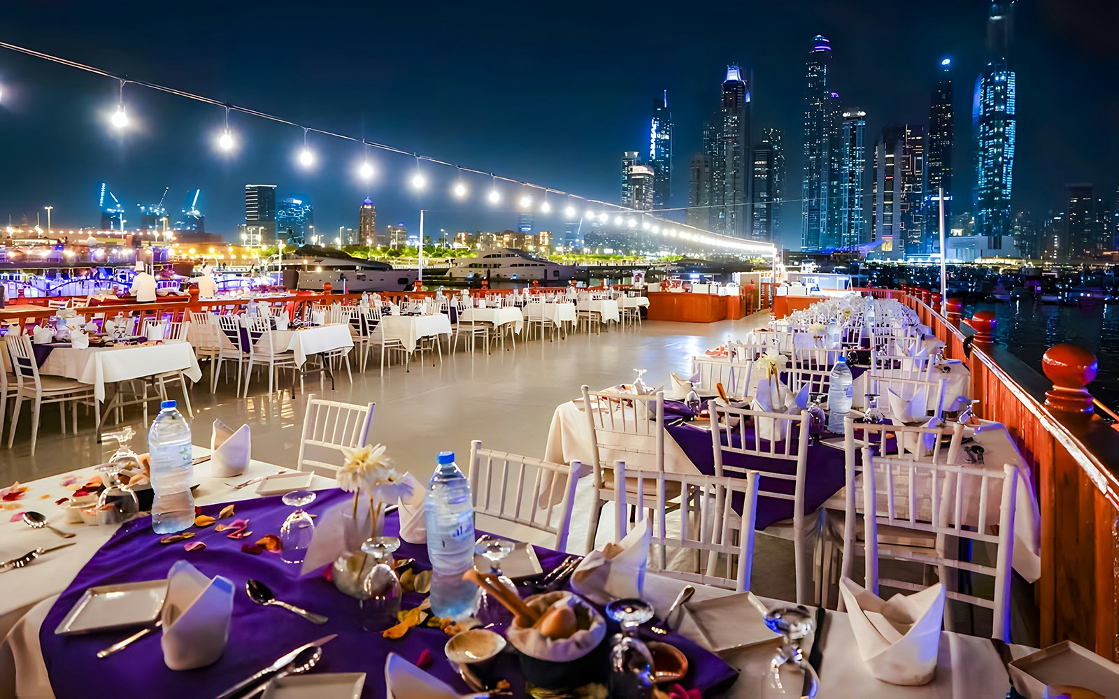 Top deck view of Dubai Marina during 2-hour luxury dhow dinner cruise with skyline in background.