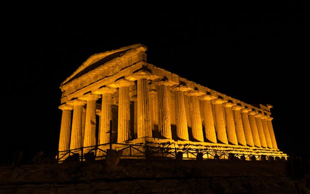 Illuminated Greek temple ruin at night, Valley of the Temples, Agrigento, Sicily.