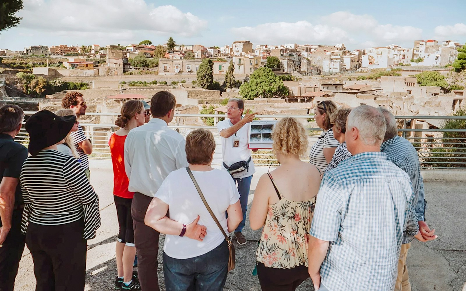 Archaeologist explaining Herculaneum ruins to tourists in Naples, Italy.