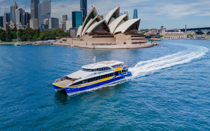 Cruise boat near Sydney Opera House during Sydney Comedy Festival.