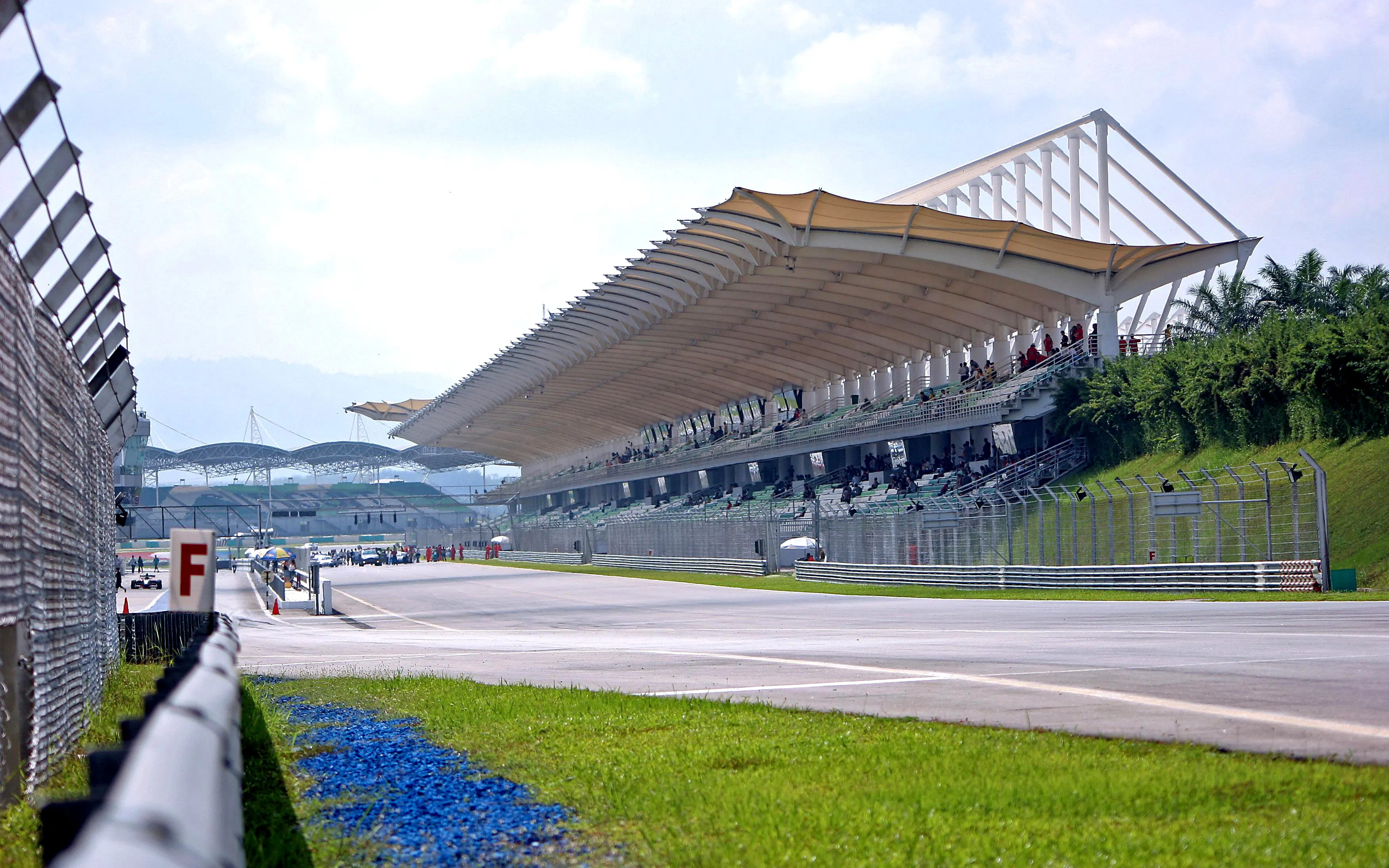 Grandstand view of Sepang International Circuit, Malaysia, with track and spectators.