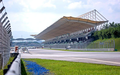 Grandstand view of Sepang International Circuit, Malaysia, with track and spectators.