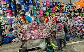 Lucha Libre merchandise stall with masks and toys at Arena Mexico.