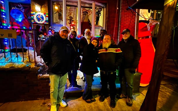 Group enjoying holiday lights display in Philadelphia during a festive tour.