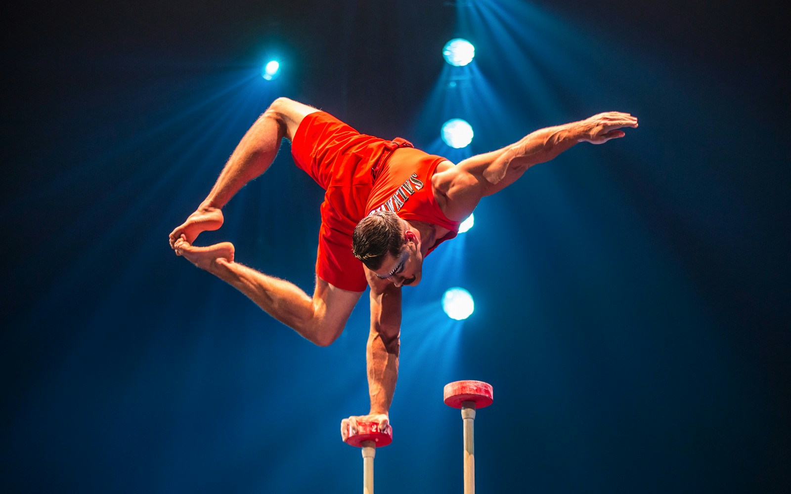 Acrobat performing handstand on canes at Cirque du Soleil: LUZIA in New York.
