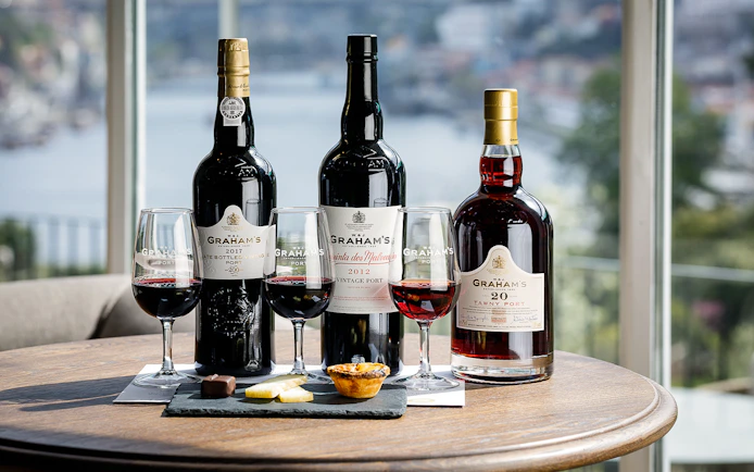 Graham's Port wine bottles and glasses with tastings at a table in Porto.