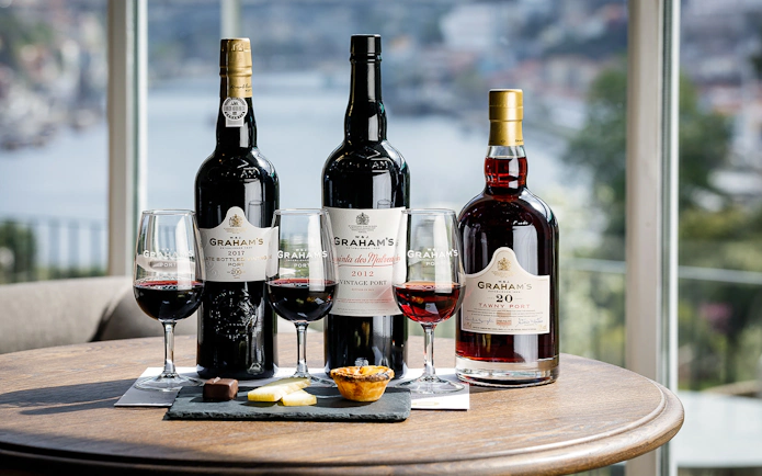 Graham's Port wine bottles and glasses with tastings at a table in Porto.