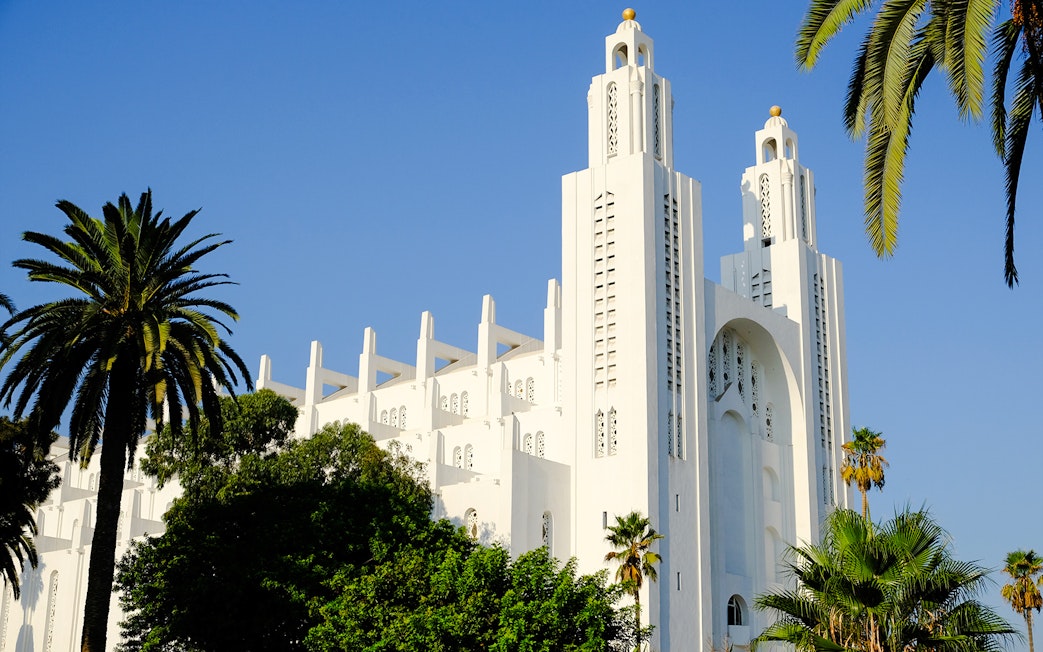 Casablanca Cathedral in Morocco with palm trees in the foreground.