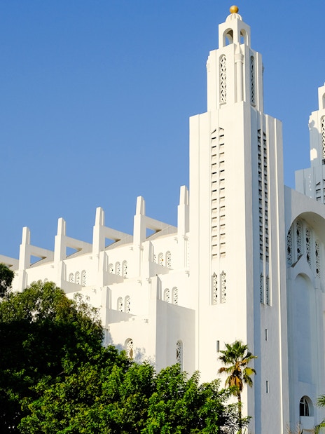 Casablanca Cathedral in Morocco with palm trees in the foreground.