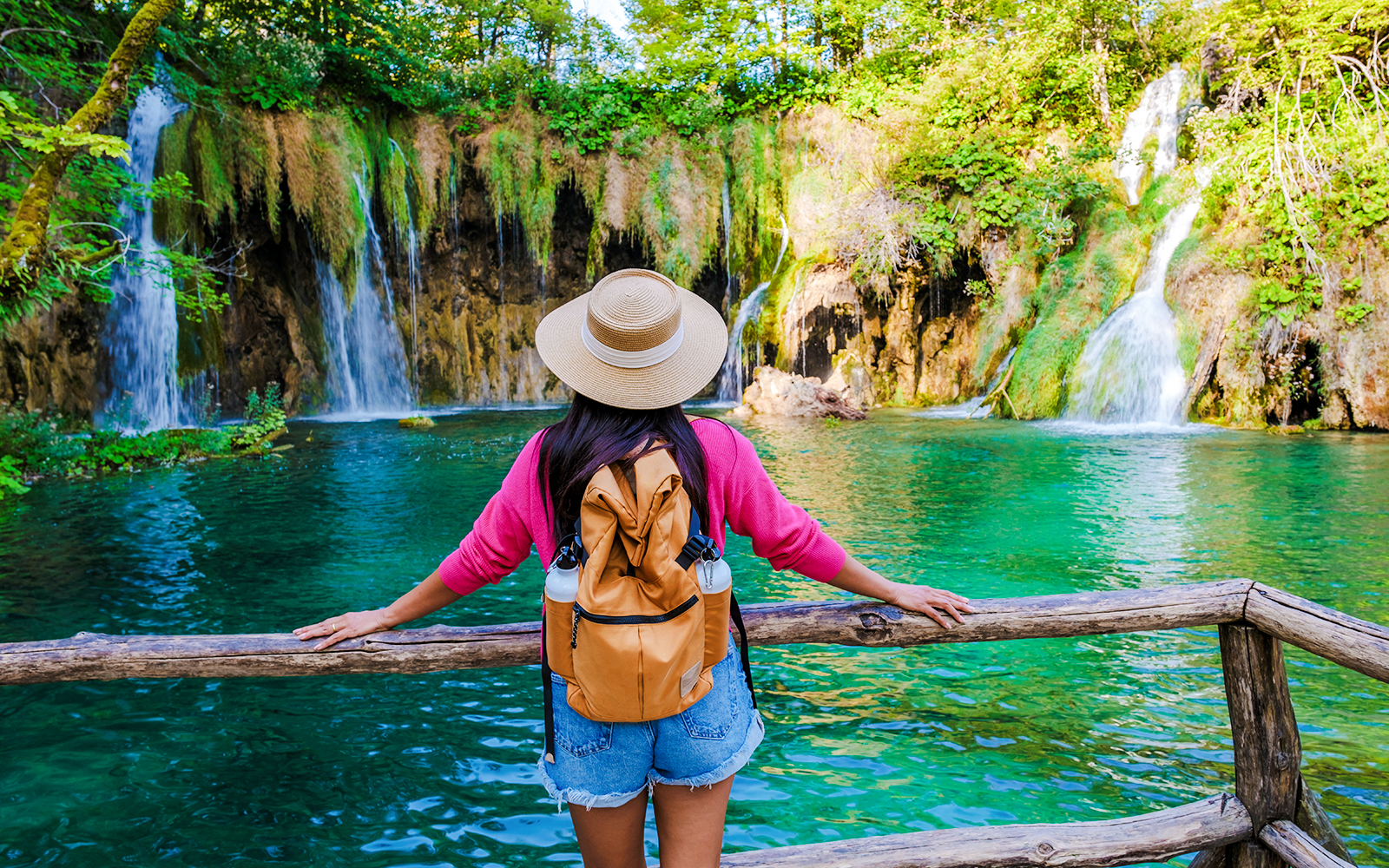 Visitor admiring waterfalls at Plitvice Lakes National Park, Croatia.