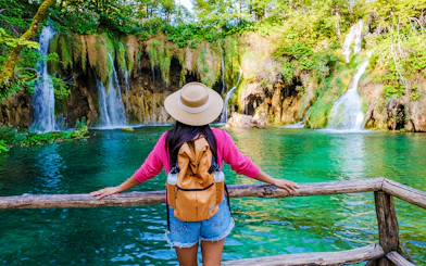 Visitor admiring waterfalls at Plitvice Lakes National Park, Croatia.