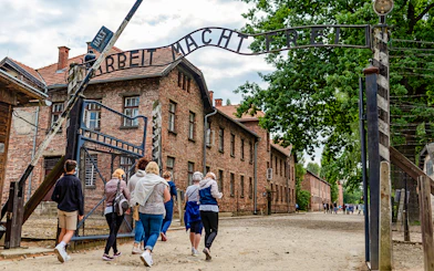 Tourists entering Auschwitz Birkenau I through the main gate.
