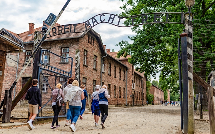 Tourists entering Auschwitz Birkenau I through the main gate.