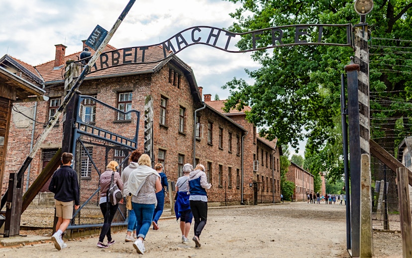 Tourists entering Auschwitz Birkenau I through the main gate.