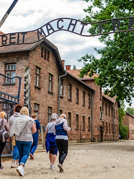 Tourists entering Auschwitz Birkenau I through the main gate.