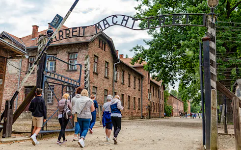 Tourists entering Auschwitz Birkenau I through the main gate.