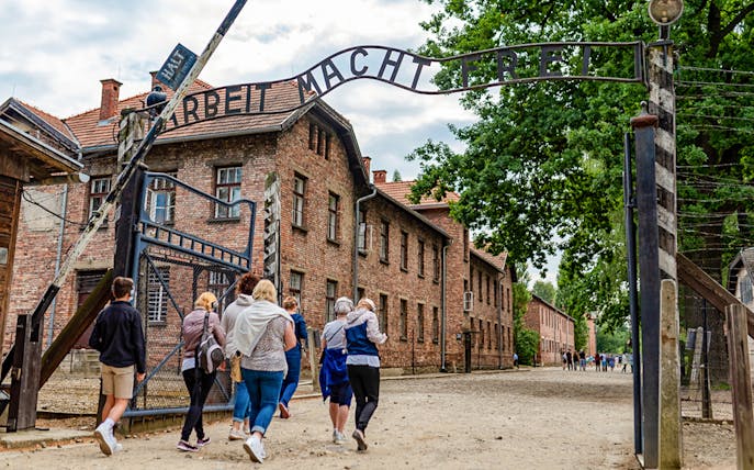 Tourists entering Auschwitz Birkenau I through the main gate.