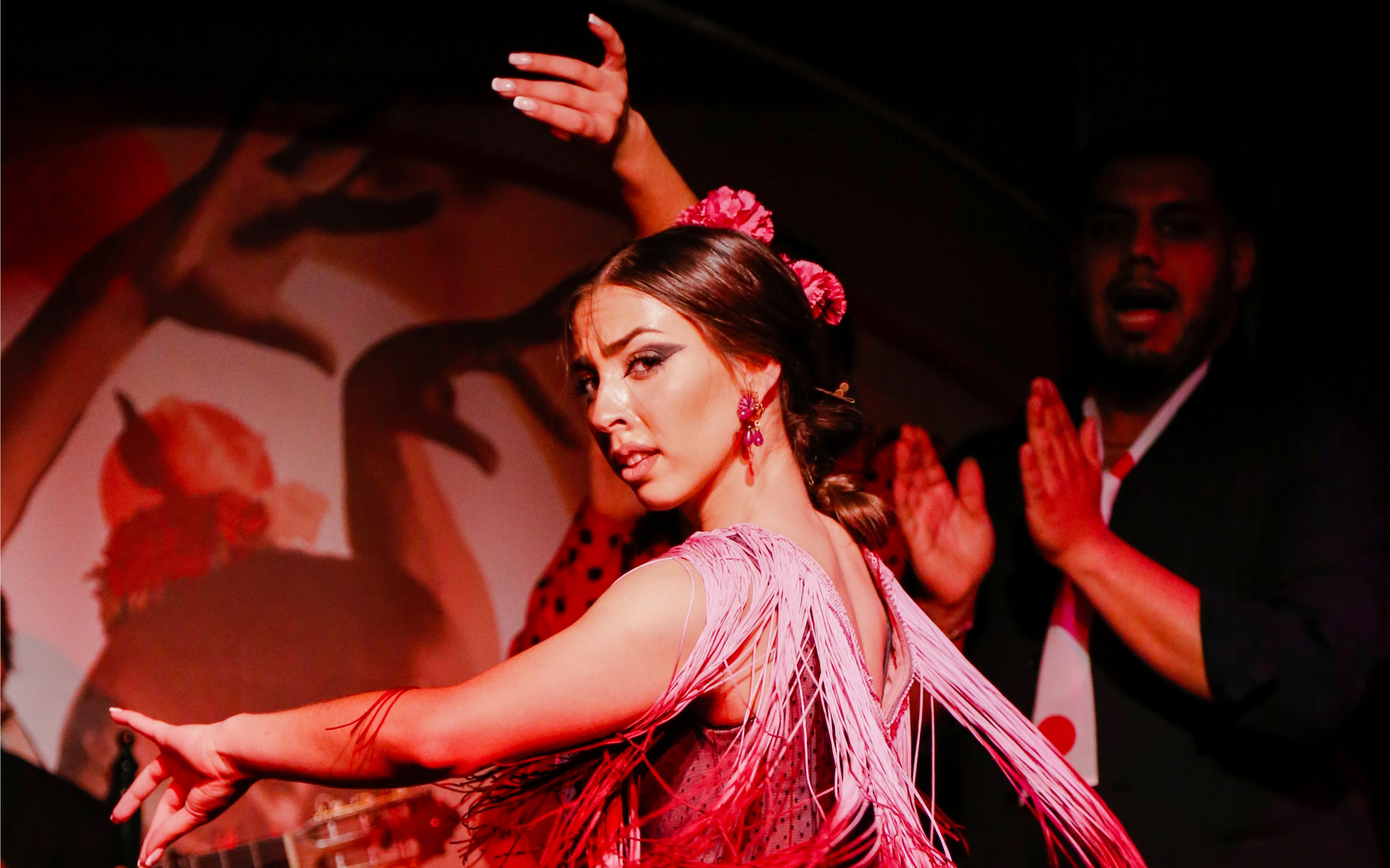 Flamenco dancer performing at El Duende by Tablao Cordobes show in vibrant attire.