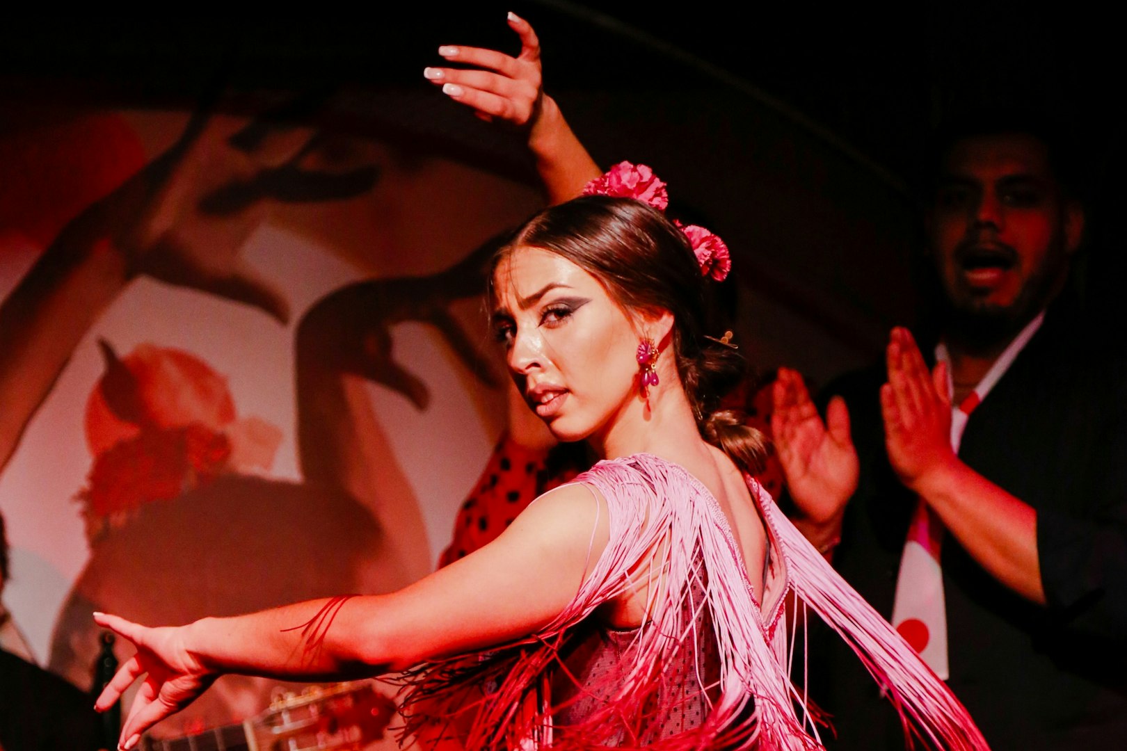 Flamenco dancer performing at El Duende by Tablao Cordobes show in vibrant attire.