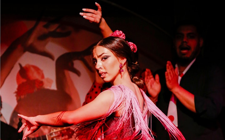 Flamenco dancer performing at El Duende by Tablao Cordobes show in vibrant attire.